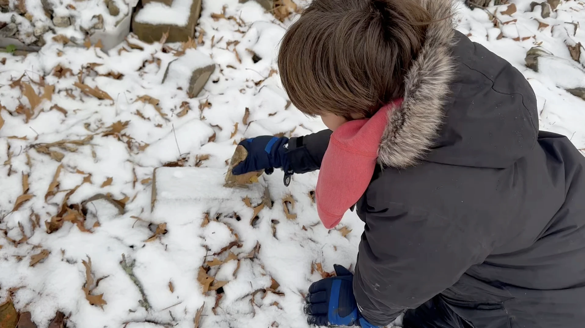 A kid smashing rocks in the backyard for foley recording